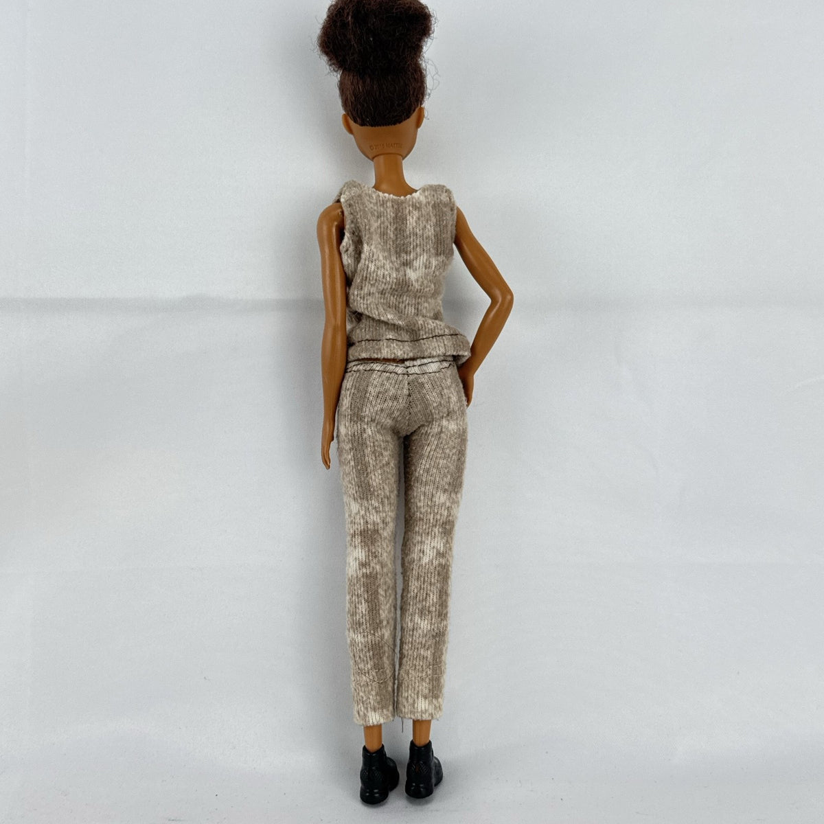 Mattel Barbie Fashionistas doll with topknot bun, wearing a heathered knit two-piece outfit and black ankle boots.