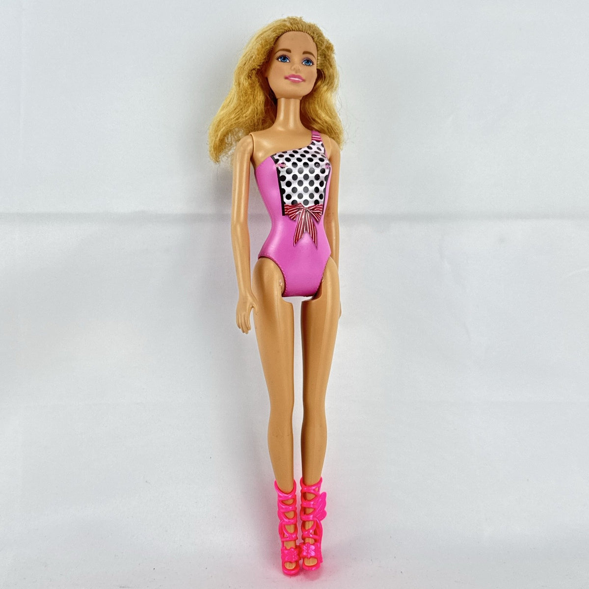 Mattel Barbie 11-inch doll wearing molded pink and polka dot swimsuit with pink strappy heels