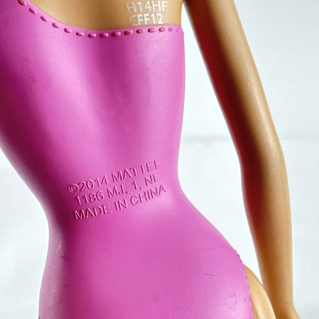 Mattel Barbie 11-inch doll wearing molded pink and polka dot swimsuit with pink strappy heels