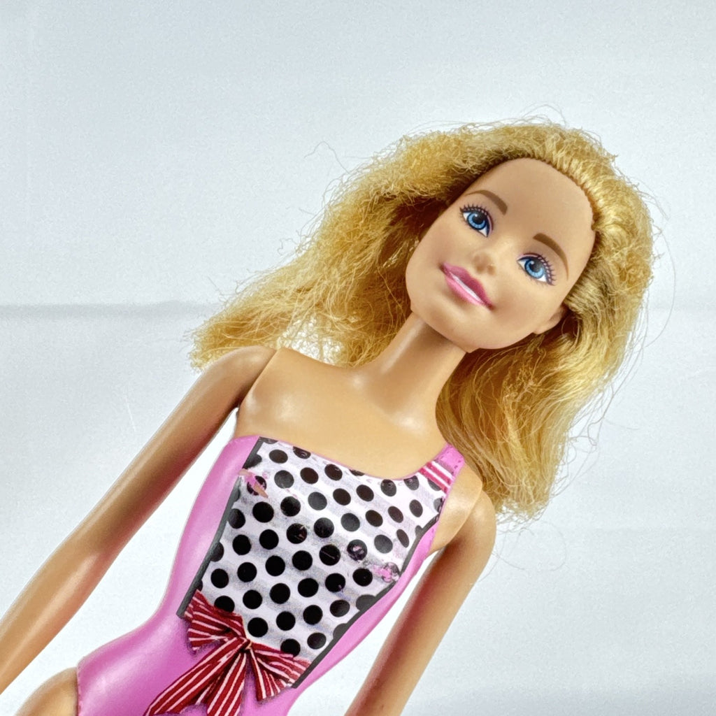 Mattel Barbie 11-inch doll wearing molded pink and polka dot swimsuit with pink strappy heels