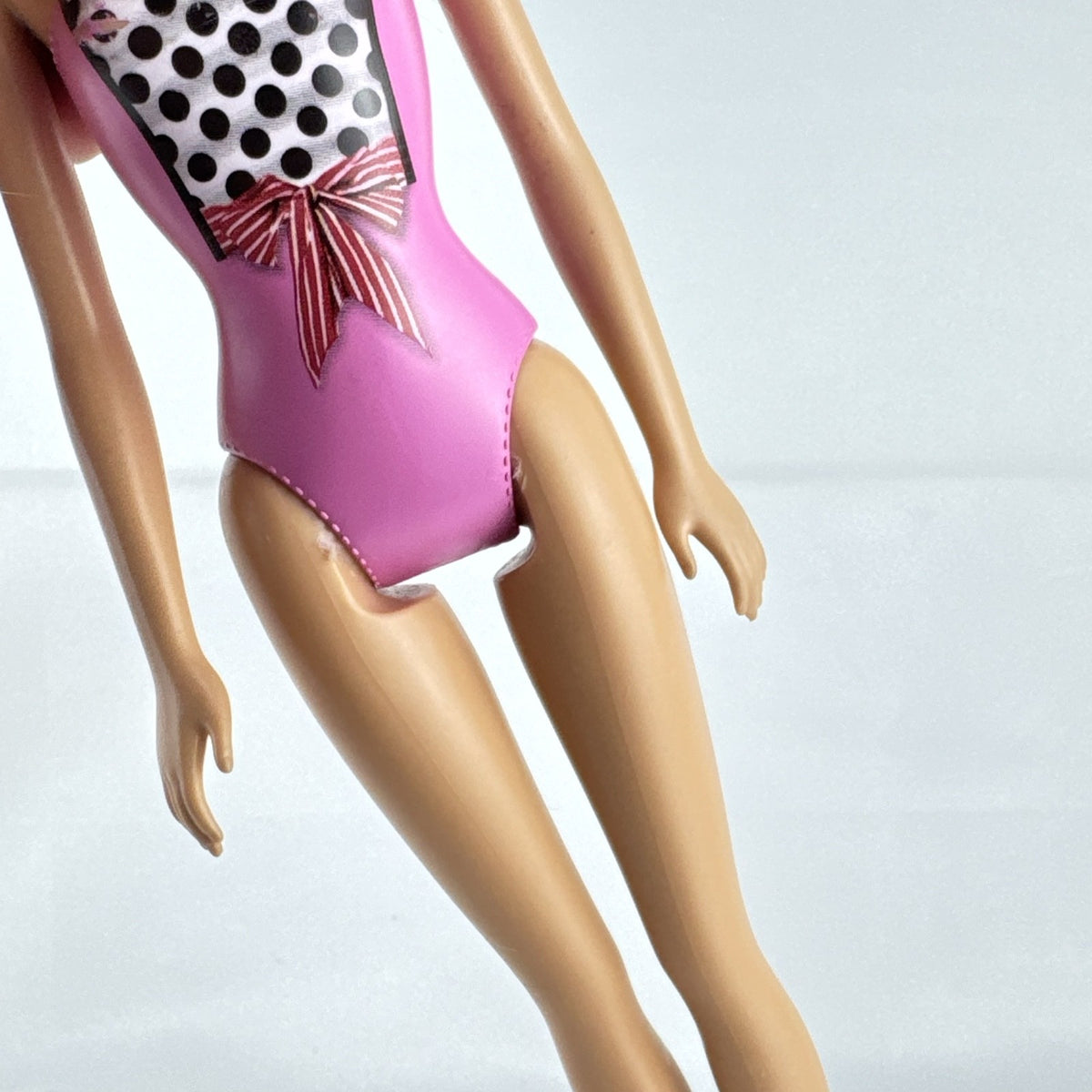 Mattel Barbie 11-inch doll wearing molded pink and polka dot swimsuit with pink strappy heels