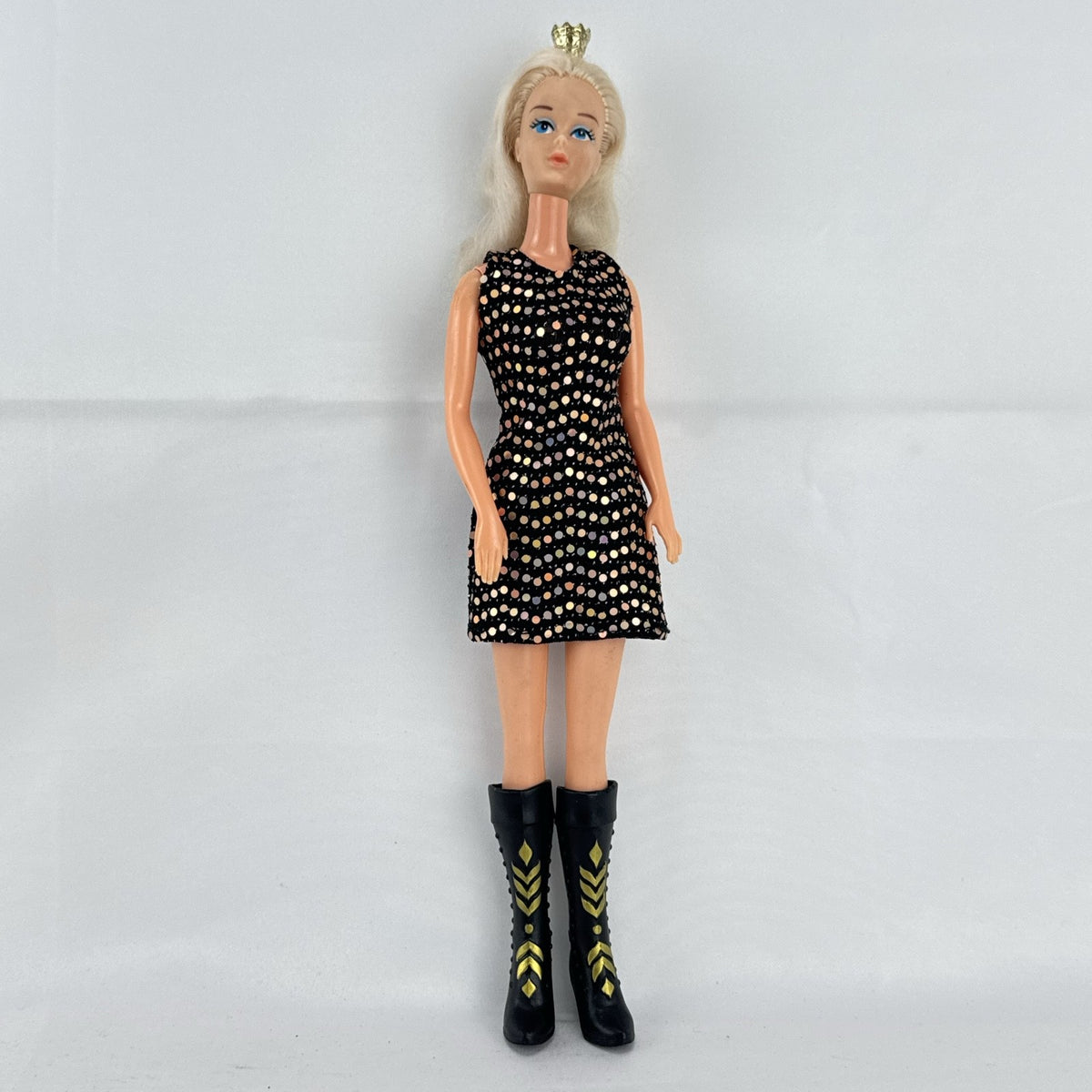 Mattel blonde Barbie doll with Twist 'N Turn body wearing a black sequin dress and gold crown