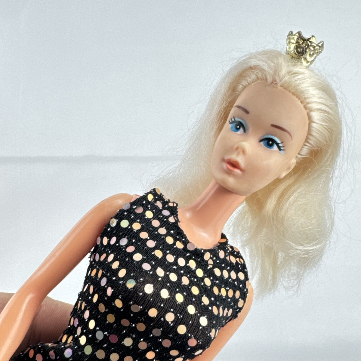 Mattel blonde Barbie doll with Twist 'N Turn body wearing a black sequin dress and gold crown