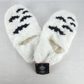 Hyde & EEK! Boutique ivory faux-fur slipper socks with black bat silhouettes and non-slip treads in women's size M/L.