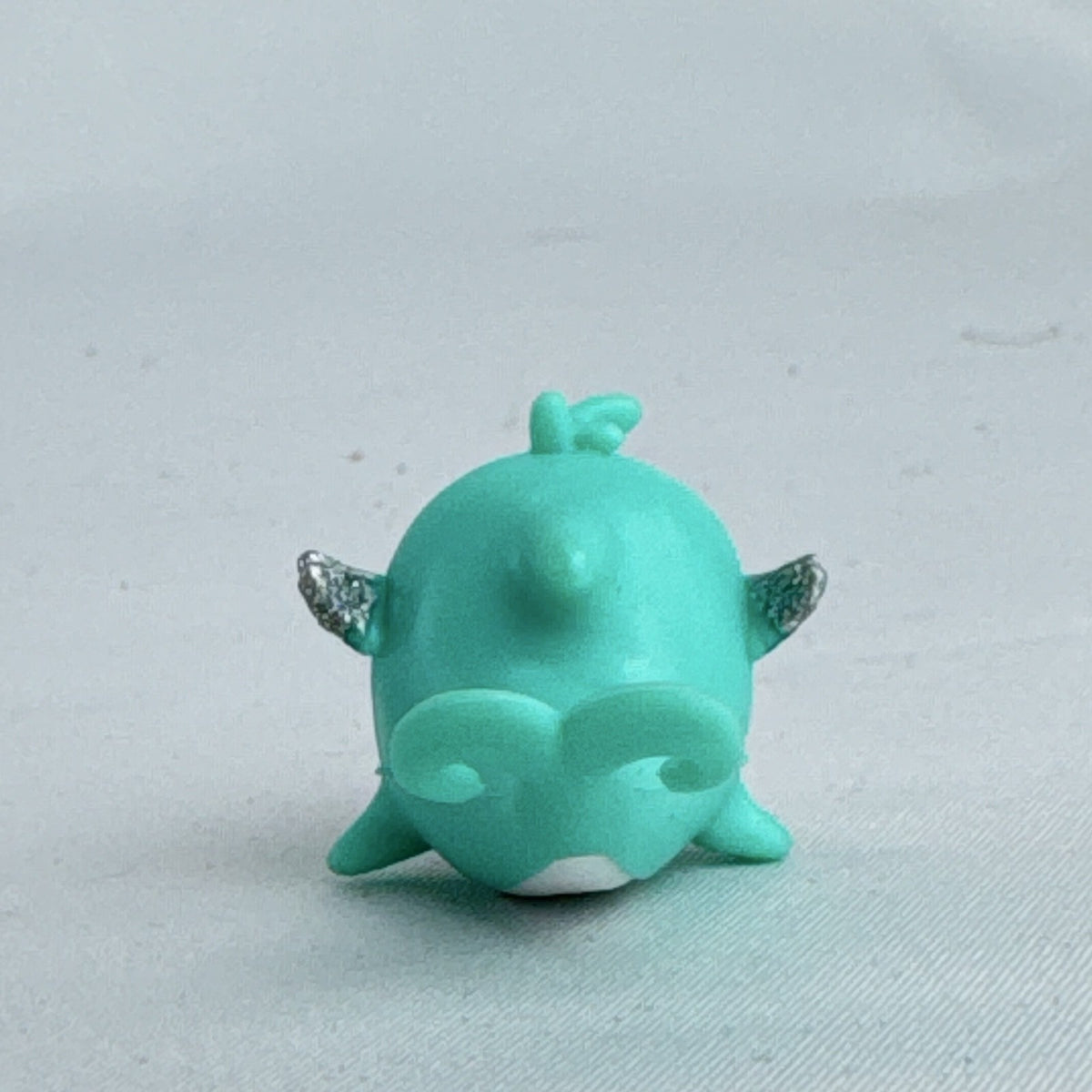 Spin Master Hatchimals CollEGGtibles Mermal Magic teal dolphin miniature figure with silver glitter wings
