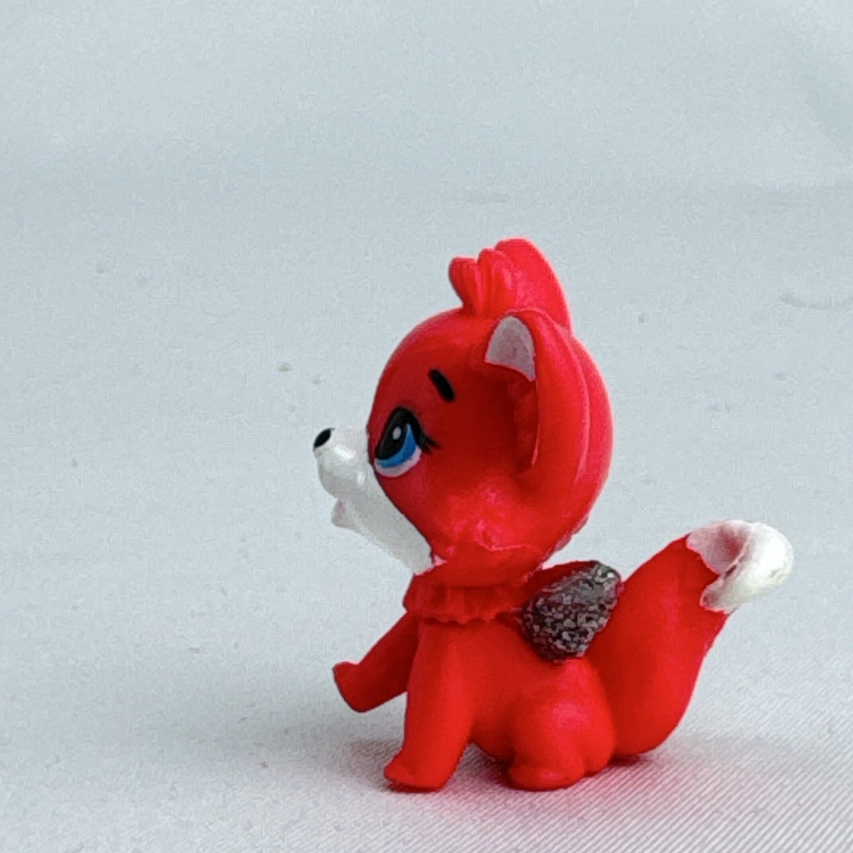 Spin Master Hatchimals Colleggtibles red fox miniature figure with silver glitter wings and winking face