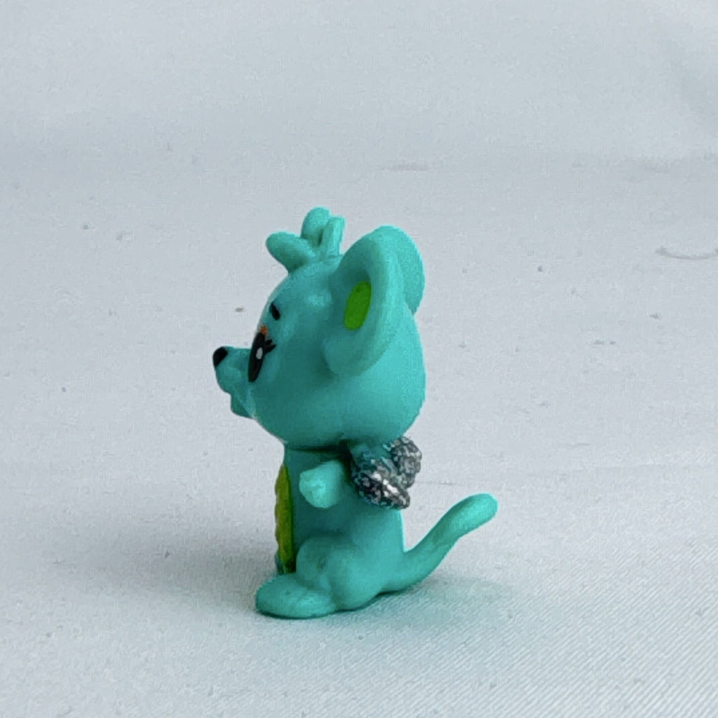 Spin Master Hatchimals CollEGGtibles mini figure in teal and lime green with silver glitter wings.