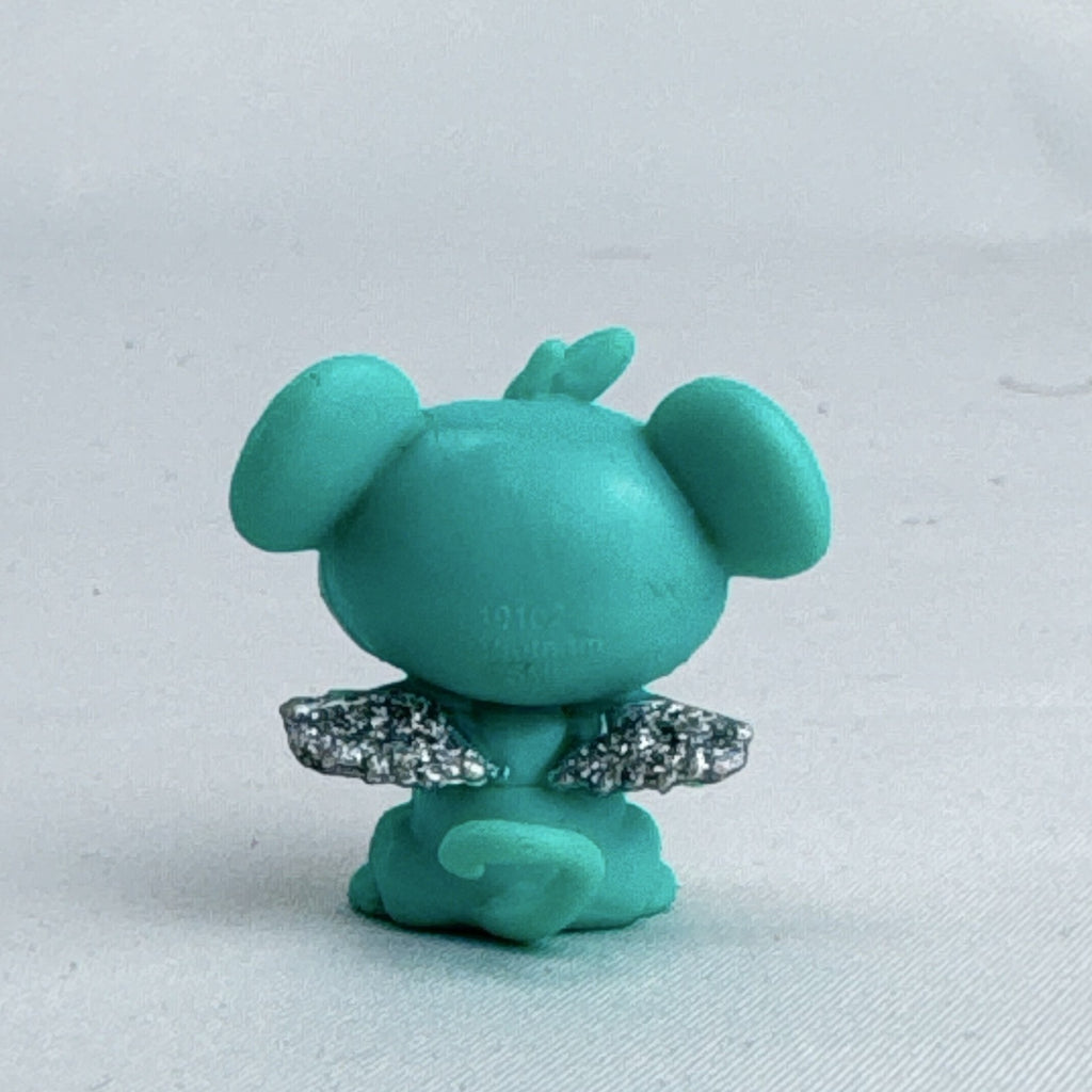 Spin Master Hatchimals CollEGGtibles mini figure in teal and lime green with silver glitter wings.