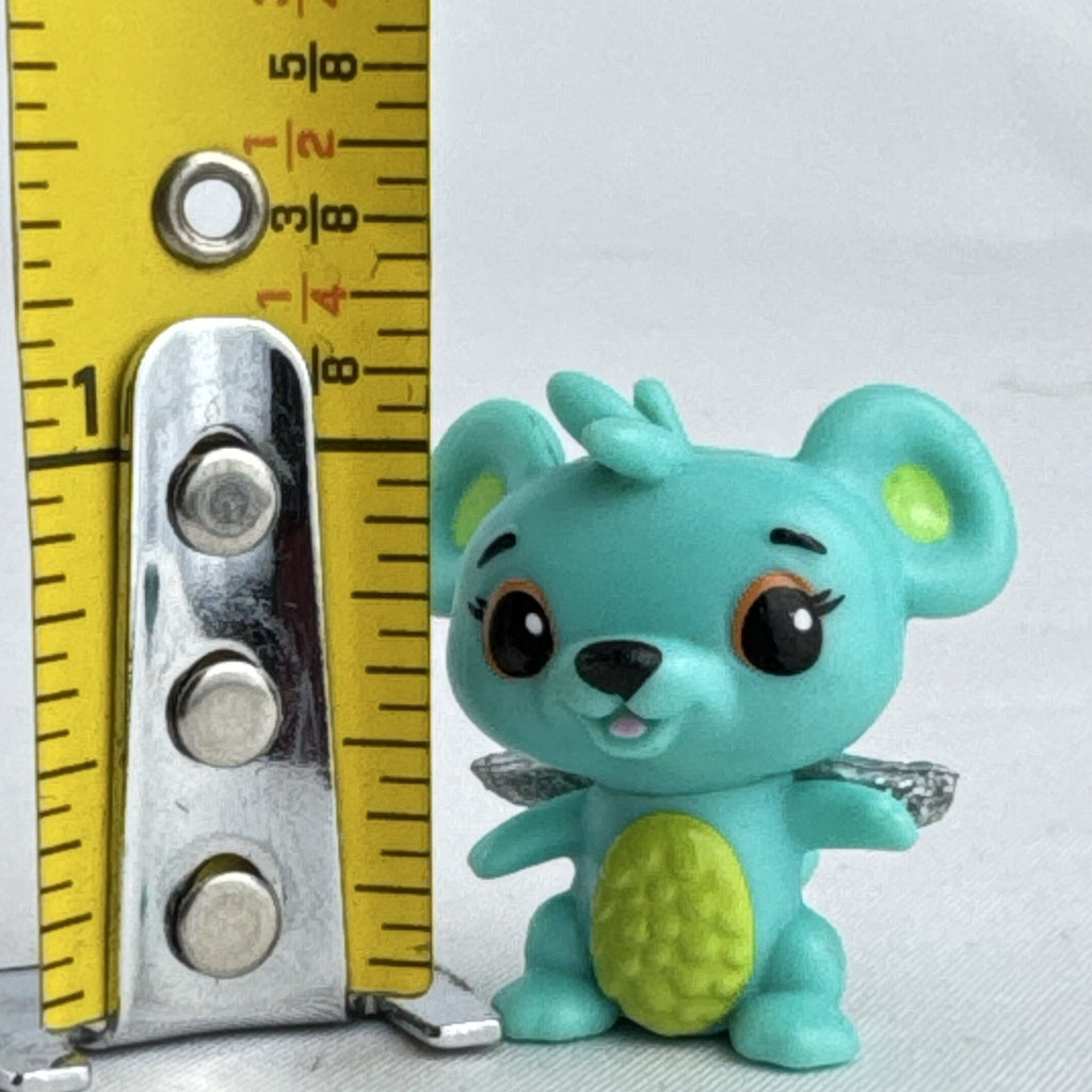 Spin Master Hatchimals CollEGGtibles mini figure in teal and lime green with silver glitter wings.