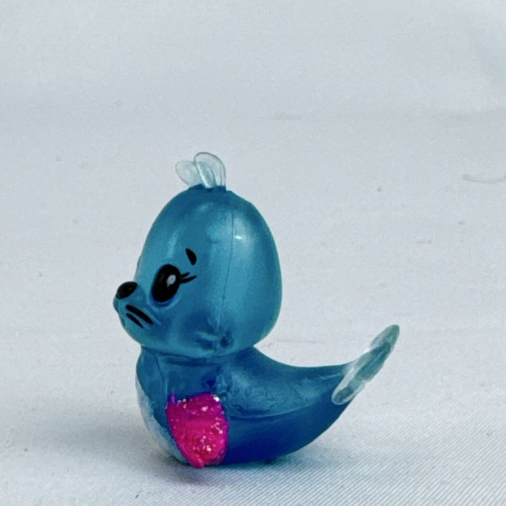 Spin Master Hatchimals CollEGGtibles translucent blue winking seal mini figure with pink glitter