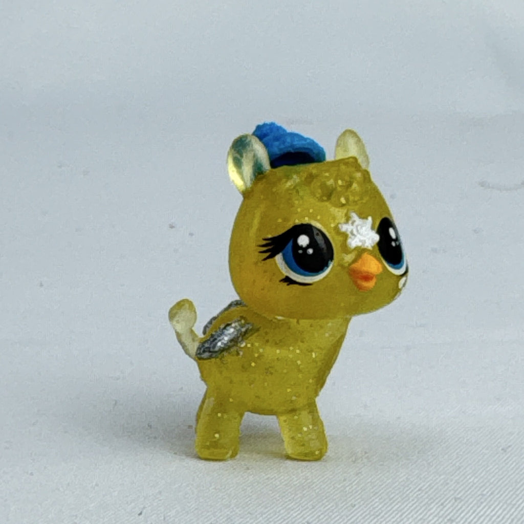 Spin Master Hatchimals CollEGGtibles translucent yellow glitter griffin mini figure wearing a blue winter beanie
