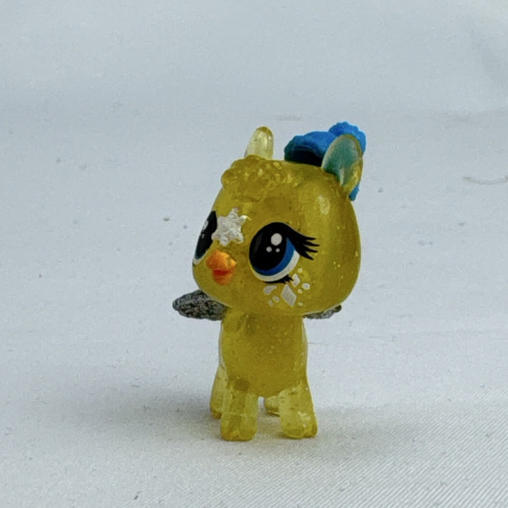 Spin Master Hatchimals CollEGGtibles translucent yellow glitter griffin mini figure wearing a blue winter beanie