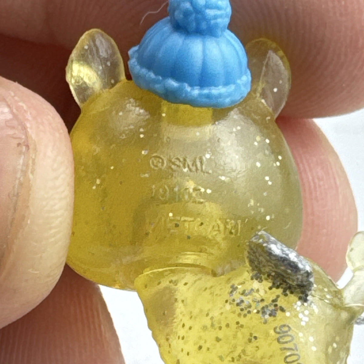 Spin Master Hatchimals CollEGGtibles translucent yellow glitter griffin mini figure wearing a blue winter beanie