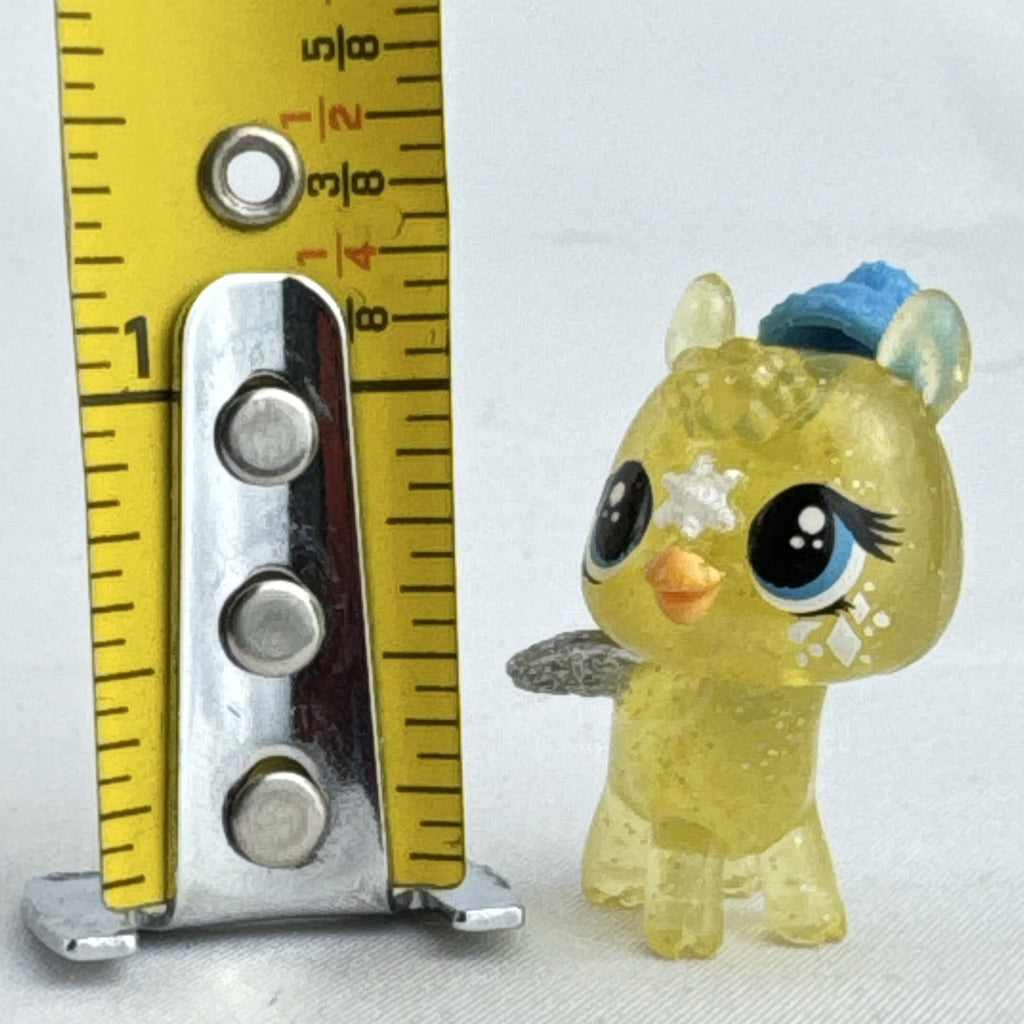 Spin Master Hatchimals CollEGGtibles translucent yellow glitter griffin mini figure wearing a blue winter beanie