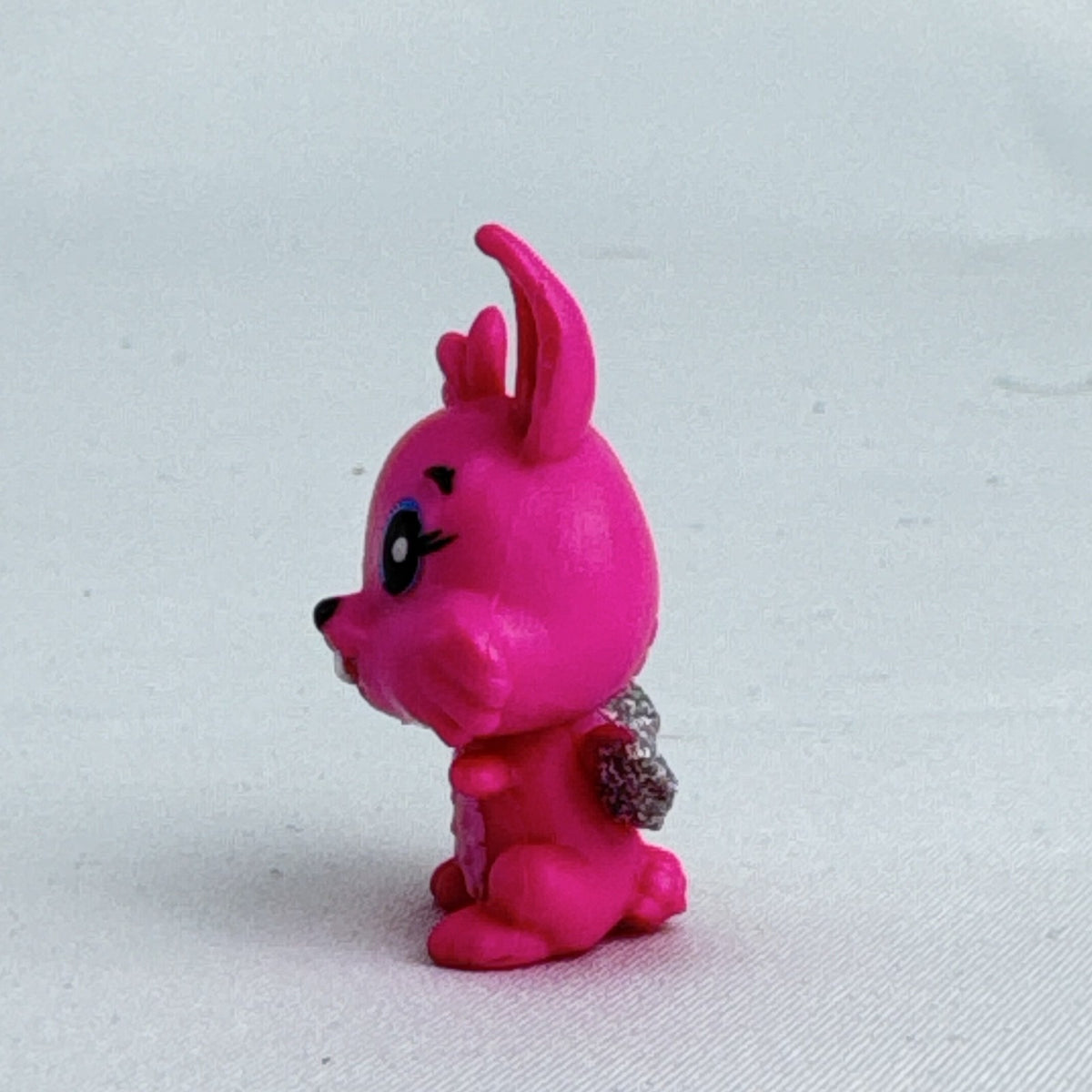 Spin Master Hatchimals CollEGGtibles pink winking bunny figure with silver glitter wings