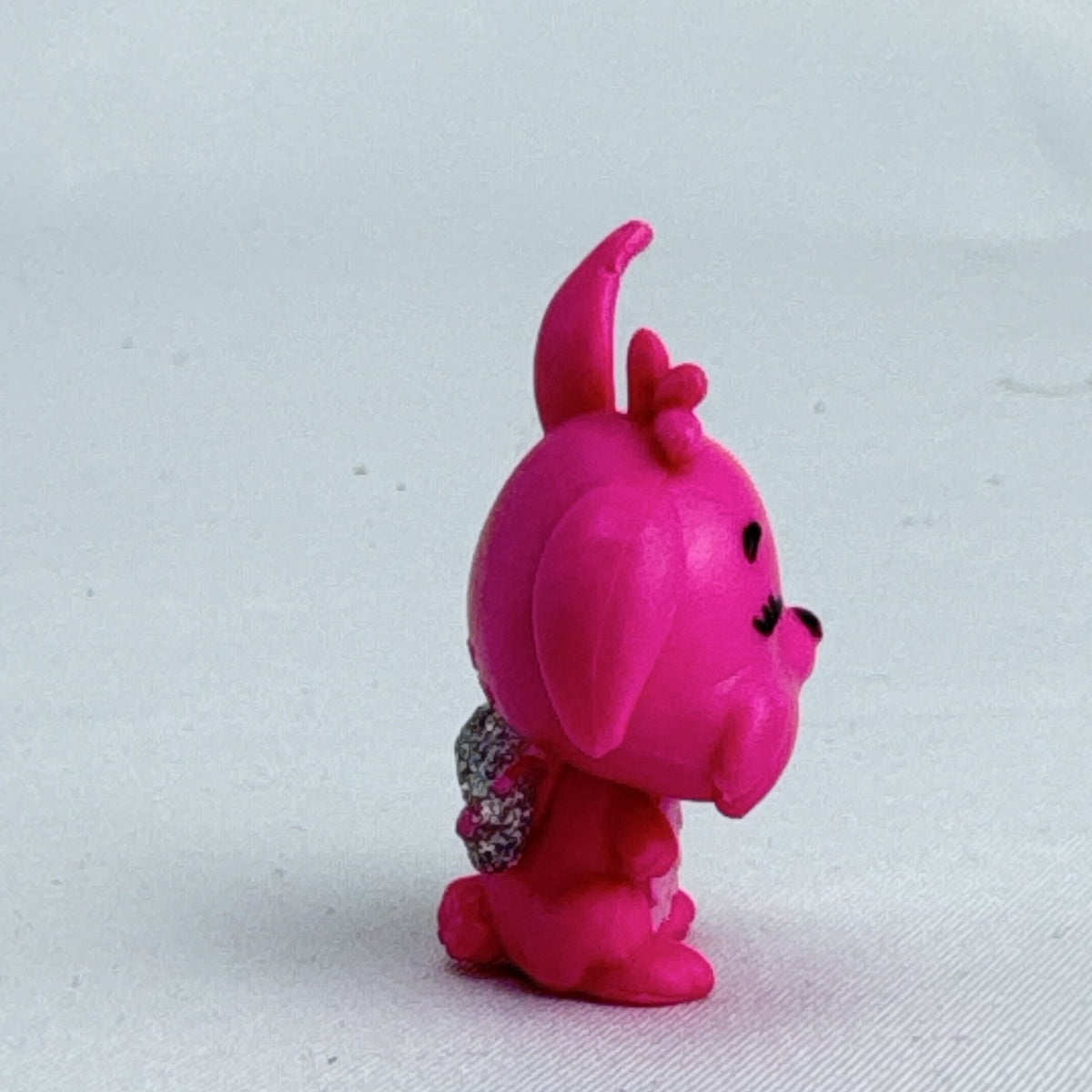 Spin Master Hatchimals CollEGGtibles pink winking bunny figure with silver glitter wings