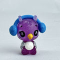 Spin Master Hatchimals CollEGGtibles miniature purple glitter penguin figure wearing molded blue earmuffs.