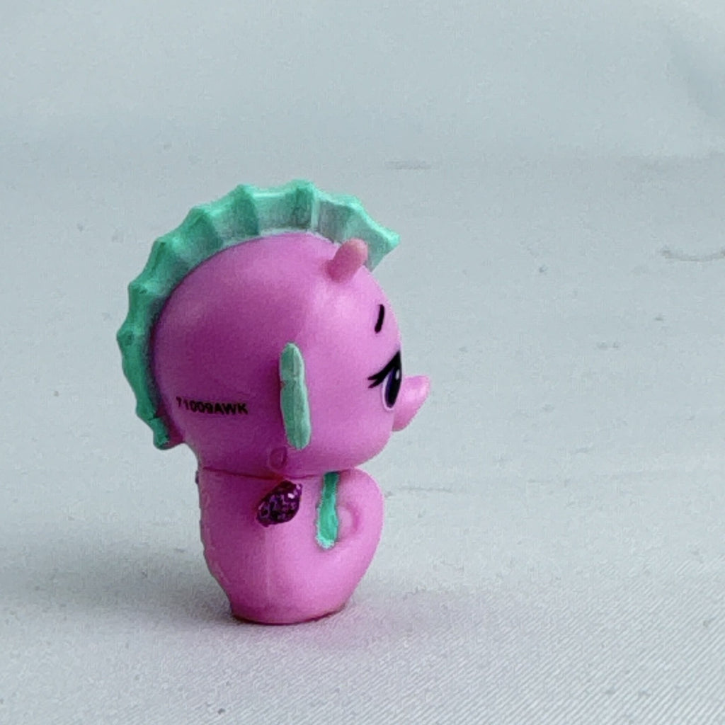 Spin Master Hatchimals Colleggtibles miniature pink seahorse figure with mint green accents and purple glitter wings.