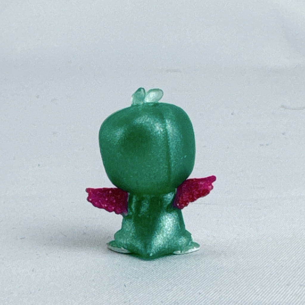 Mattel Barbie Dreamtopia miniature green shimmer penguin pet figure with pink glitter wings.