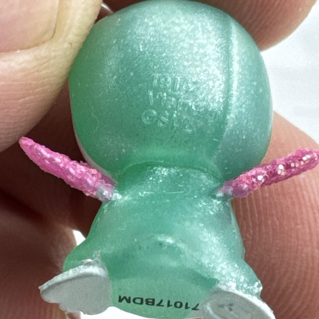 Mattel Barbie Dreamtopia miniature green shimmer penguin pet figure with pink glitter wings.