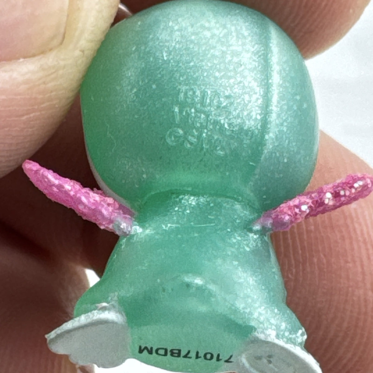 Mattel Barbie Dreamtopia miniature green shimmer penguin pet figure with pink glitter wings.