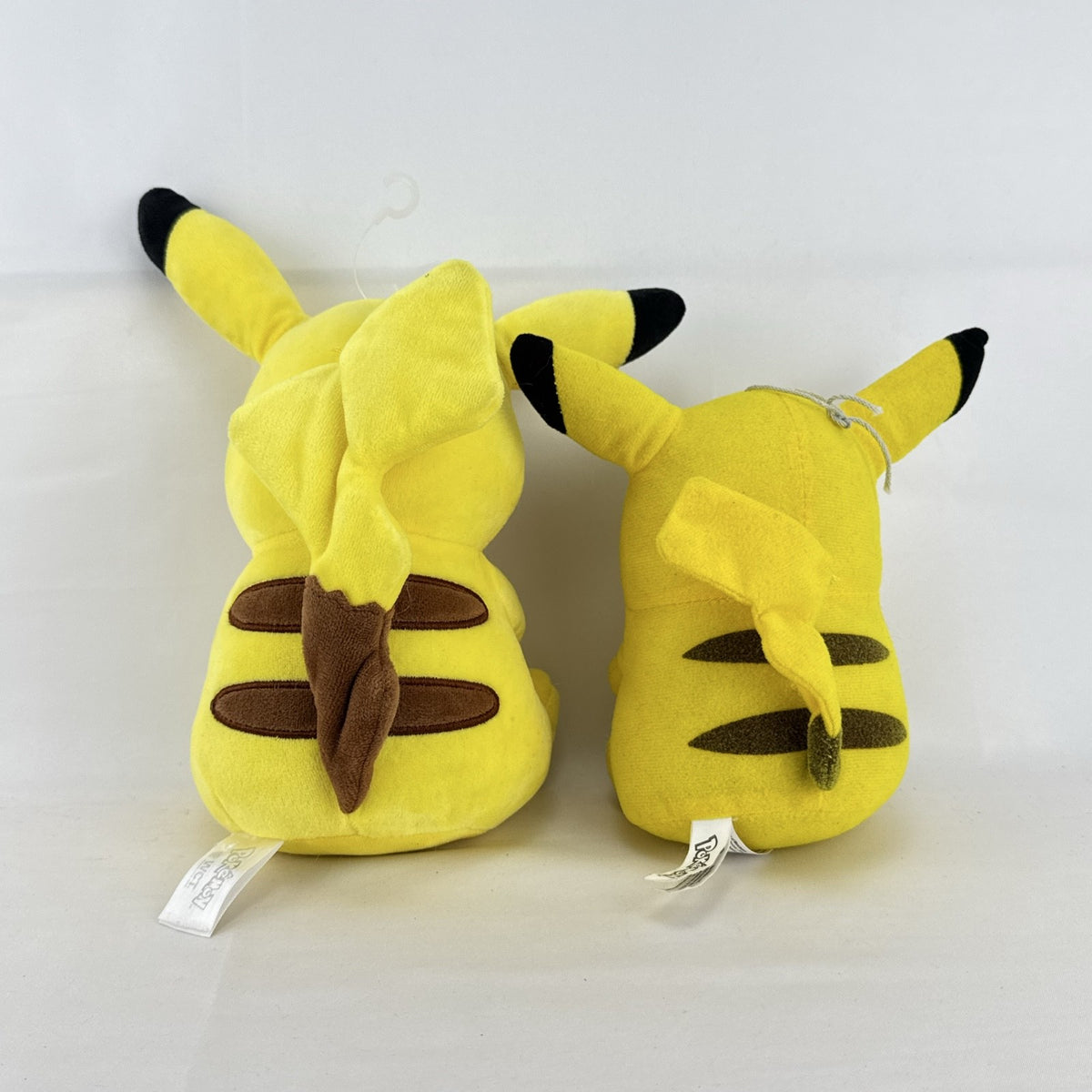Pair of two yellow Pokémon Pikachu plush stuffed animals in 7-inch and 8.5-inch sizes.