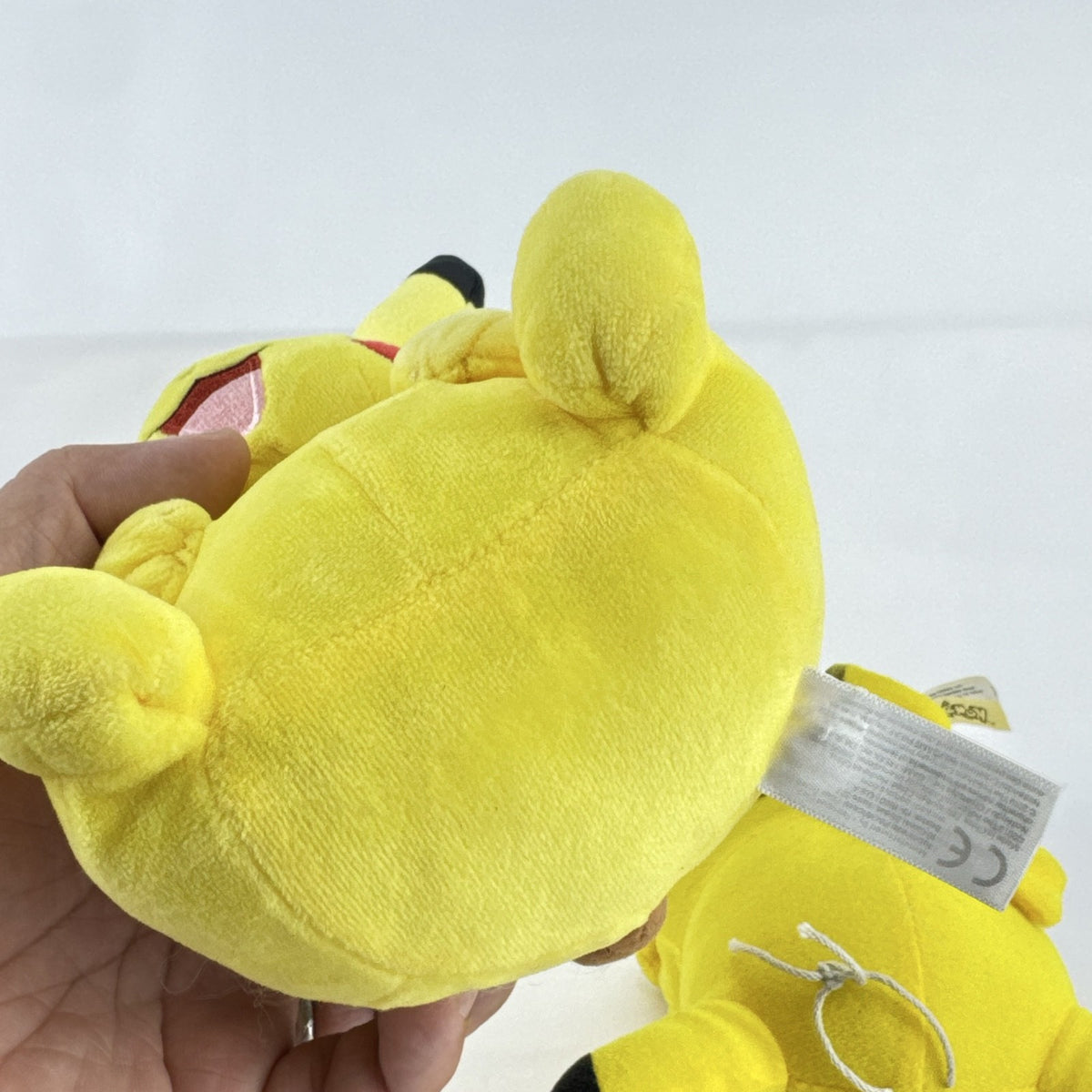 Pair of two yellow Pokémon Pikachu plush stuffed animals in 7-inch and 8.5-inch sizes.