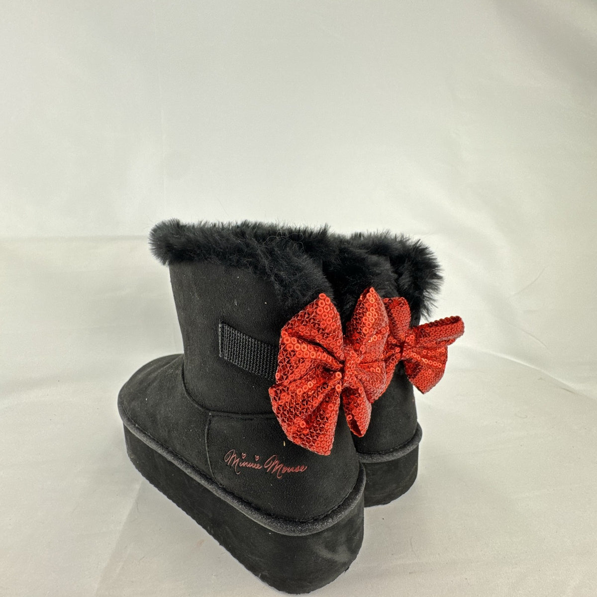 Disney Minnie Mouse black faux suede platform ankle boots with red sequin bows in women's size 8.