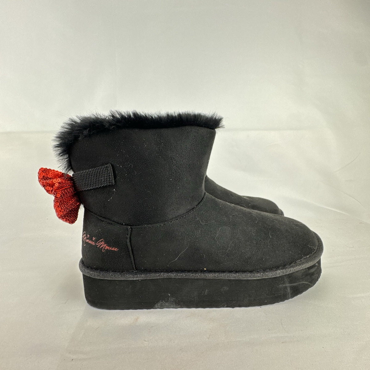 Disney Minnie Mouse black faux suede platform ankle boots with red sequin bows in women's size 8.
