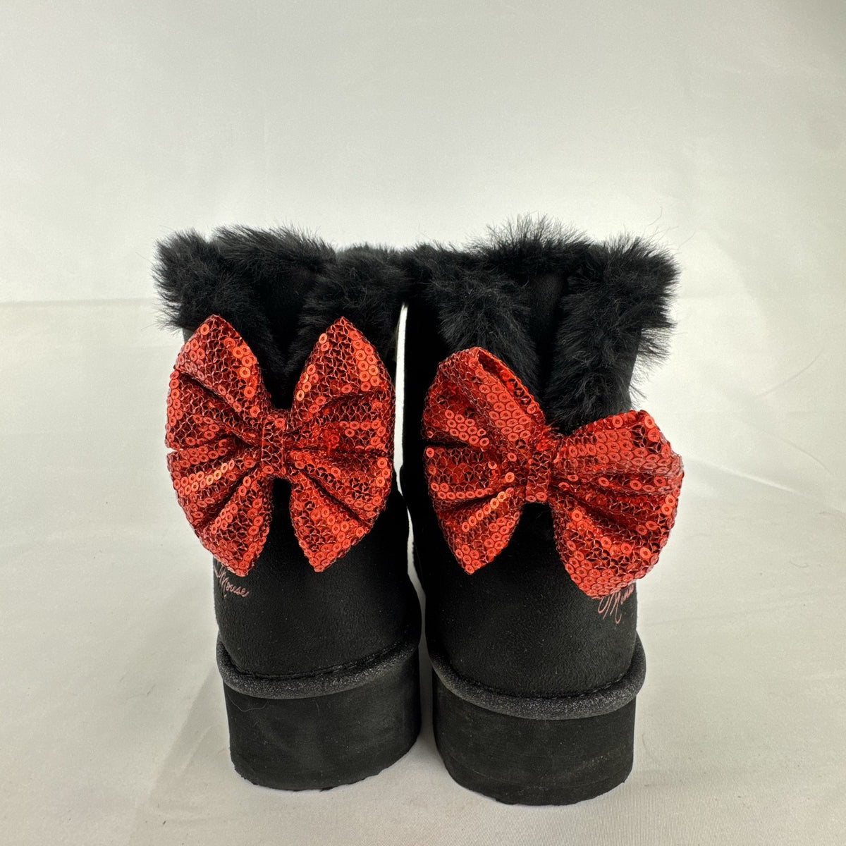 Disney Minnie Mouse black faux suede platform ankle boots with red sequin bows in women's size 8.