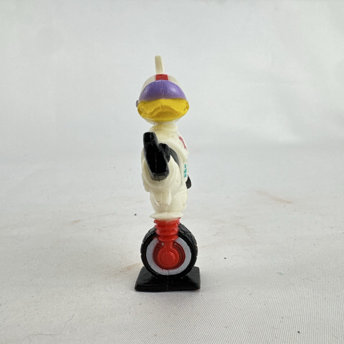 Vintage 1991 Disney and Kellogg's molded plastic Gizmoduck cereal toy figure on unicycle wheel