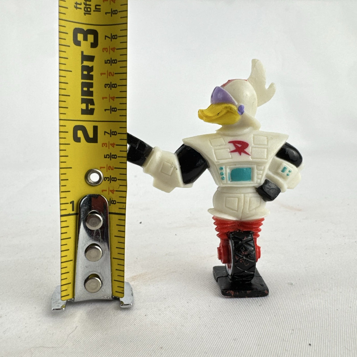 Vintage 1991 Disney and Kellogg's molded plastic Gizmoduck cereal toy figure on unicycle wheel