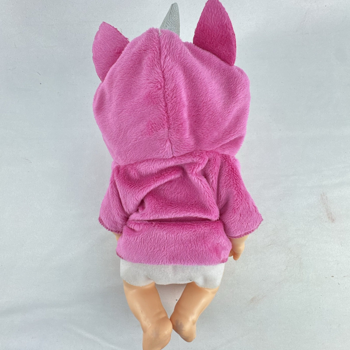 Cabbage Patch Kids 9-inch vinyl baby doll wearing a hooded pink unicorn robe with silver horn