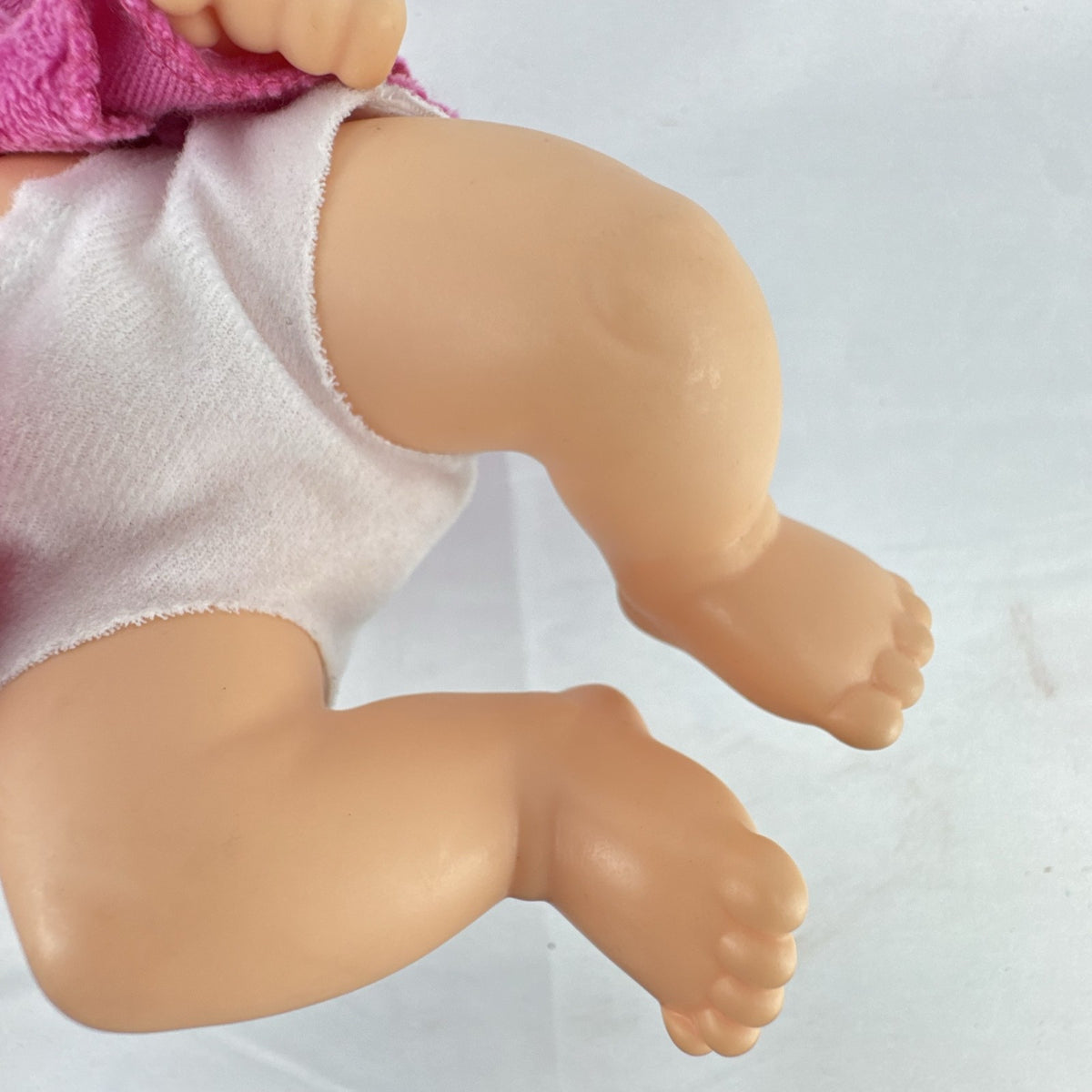 Cabbage Patch Kids 9-inch vinyl baby doll wearing a hooded pink unicorn robe with silver horn