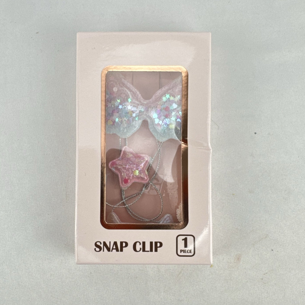 Iridescent pink angel wings snap hair clip with star dangles and glitter in original retail packaging