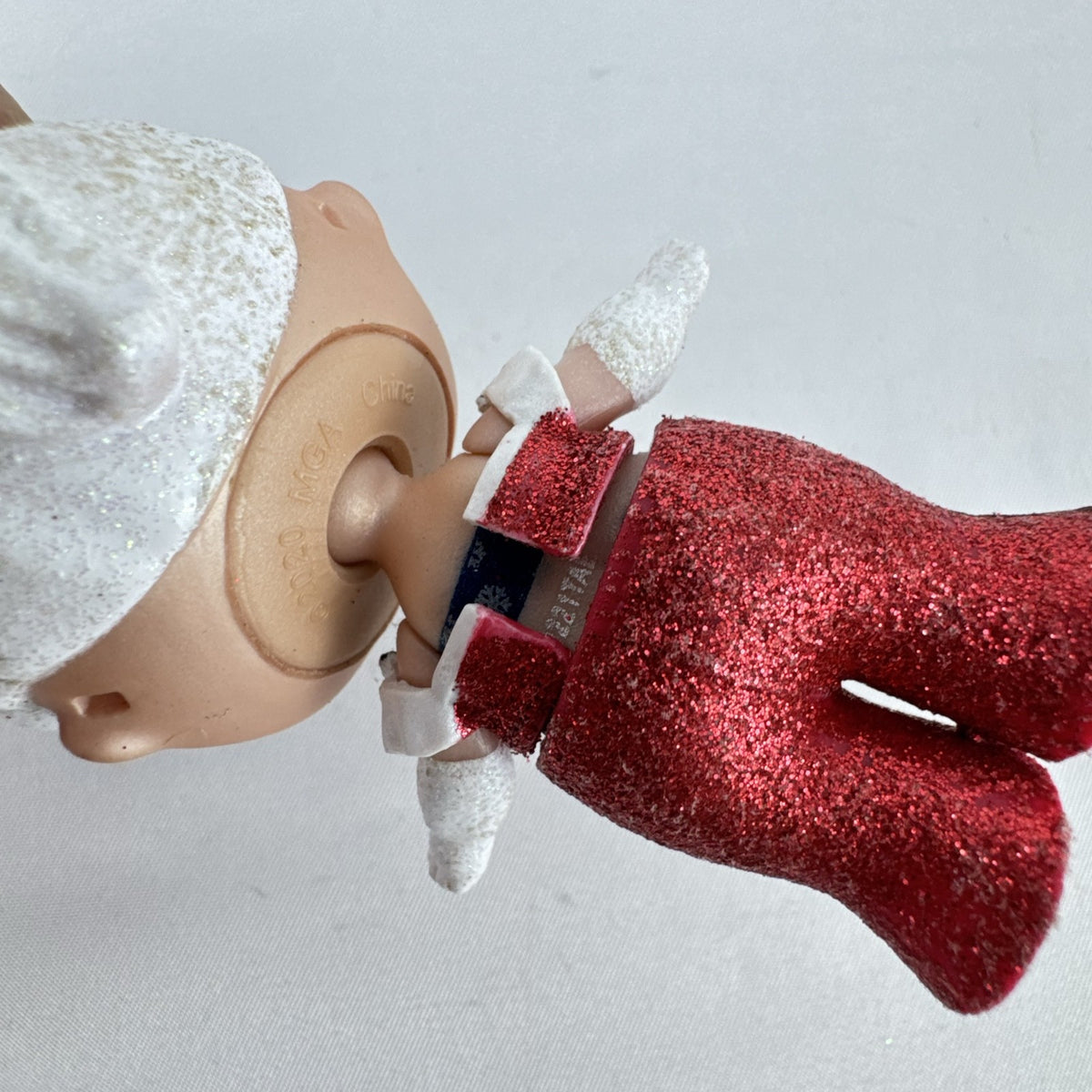 MGA L.O.L. Surprise Holiday Glitter 3-inch mini doll with white glitter hair and red sparkly outfit