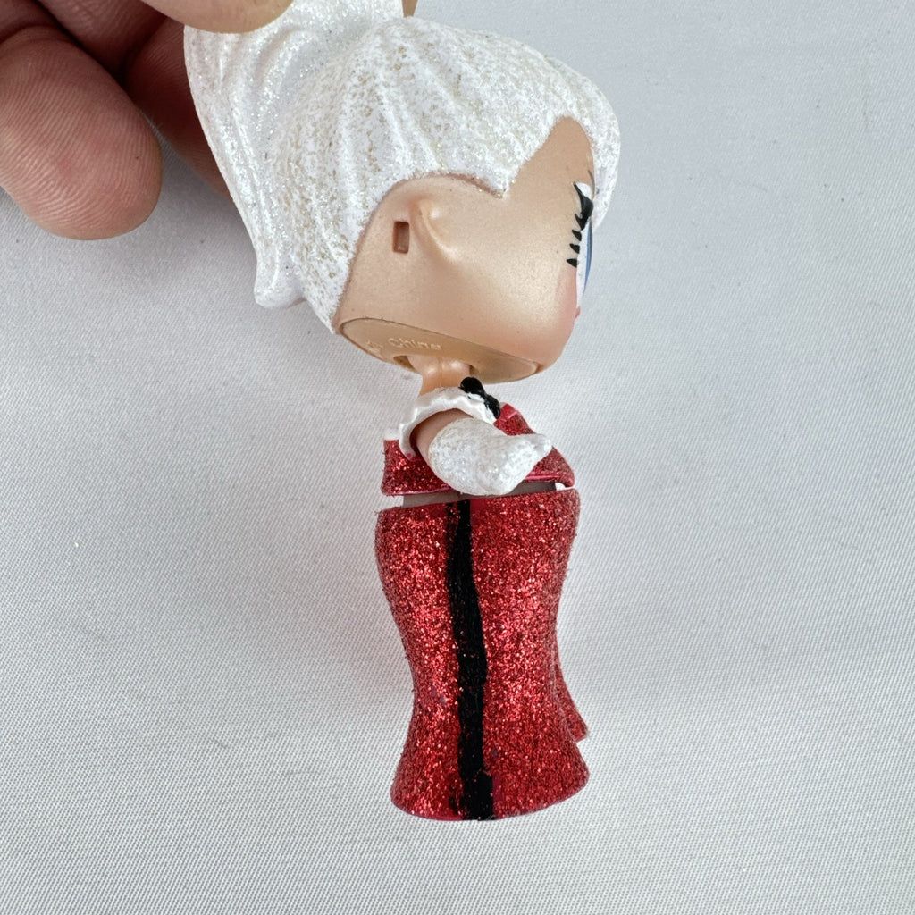MGA L.O.L. Surprise Holiday Glitter 3-inch mini doll with white glitter hair and red sparkly outfit