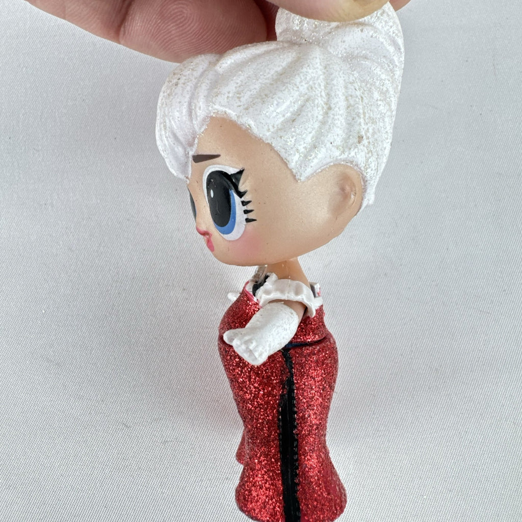 MGA L.O.L. Surprise Holiday Glitter 3-inch mini doll with white glitter hair and red sparkly outfit