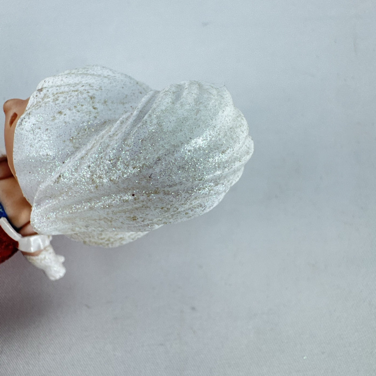 MGA L.O.L. Surprise Holiday Glitter 3-inch mini doll with white glitter hair and red sparkly outfit