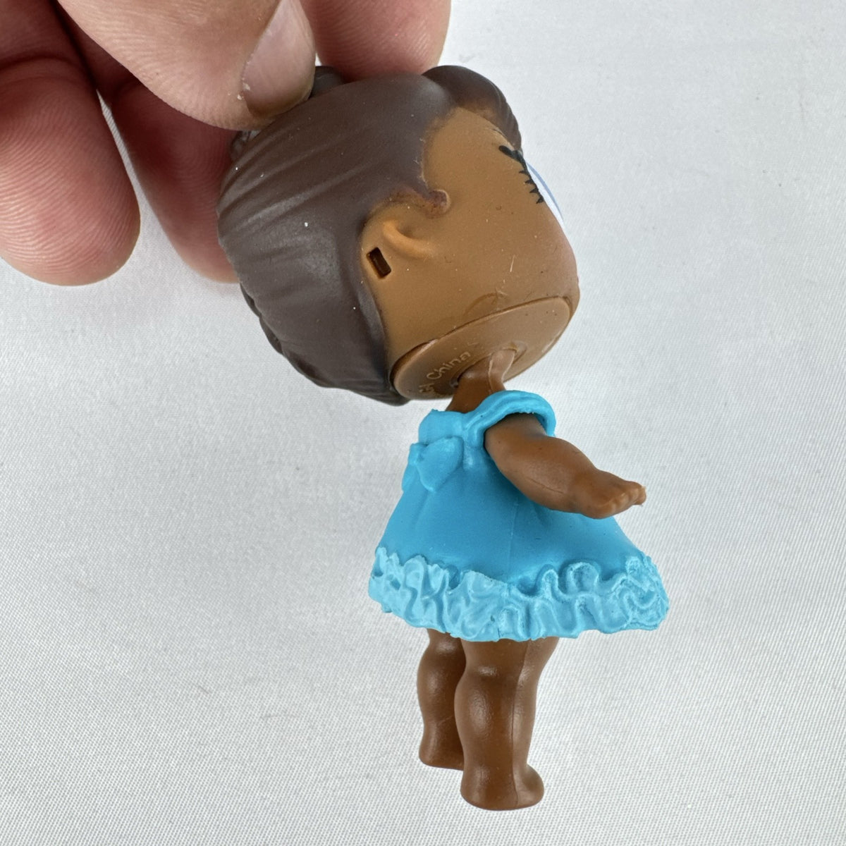 MGA L.O.L. Surprise Series 1 Royal High-Ney 3-inch doll in blue ruffled dress