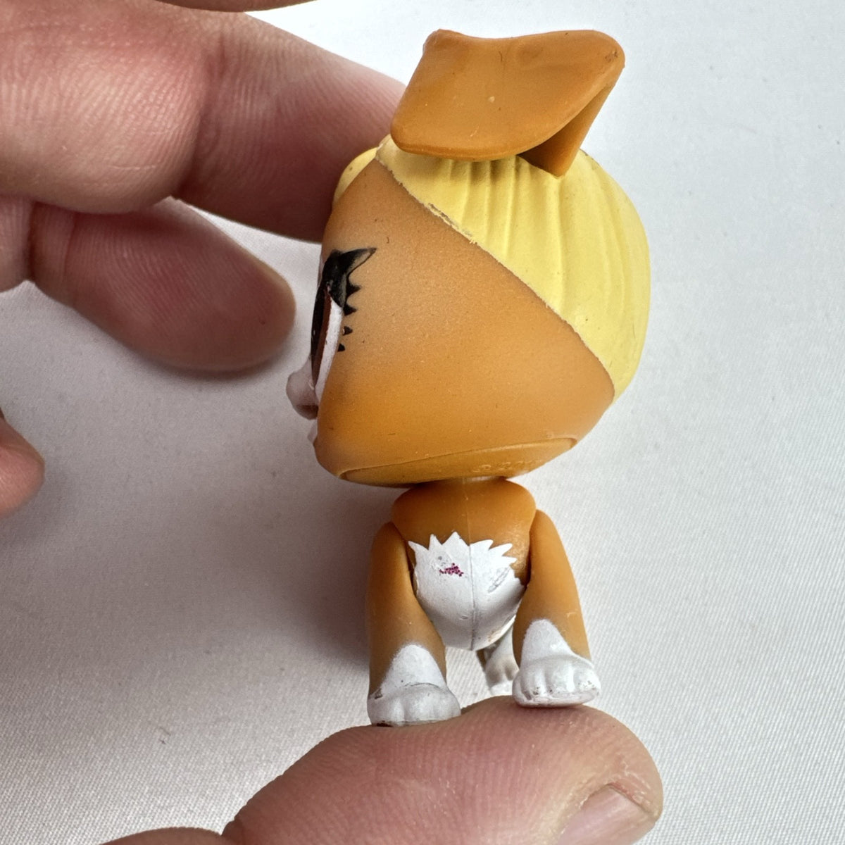 MGA L.O.L. Surprise! Pets brown vinyl dog figure with molded blonde topknot bun