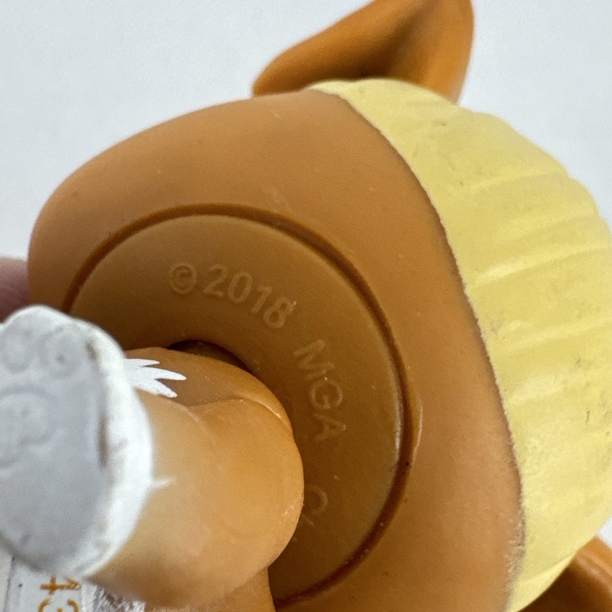 MGA L.O.L. Surprise! Pets brown vinyl dog figure with molded blonde topknot bun