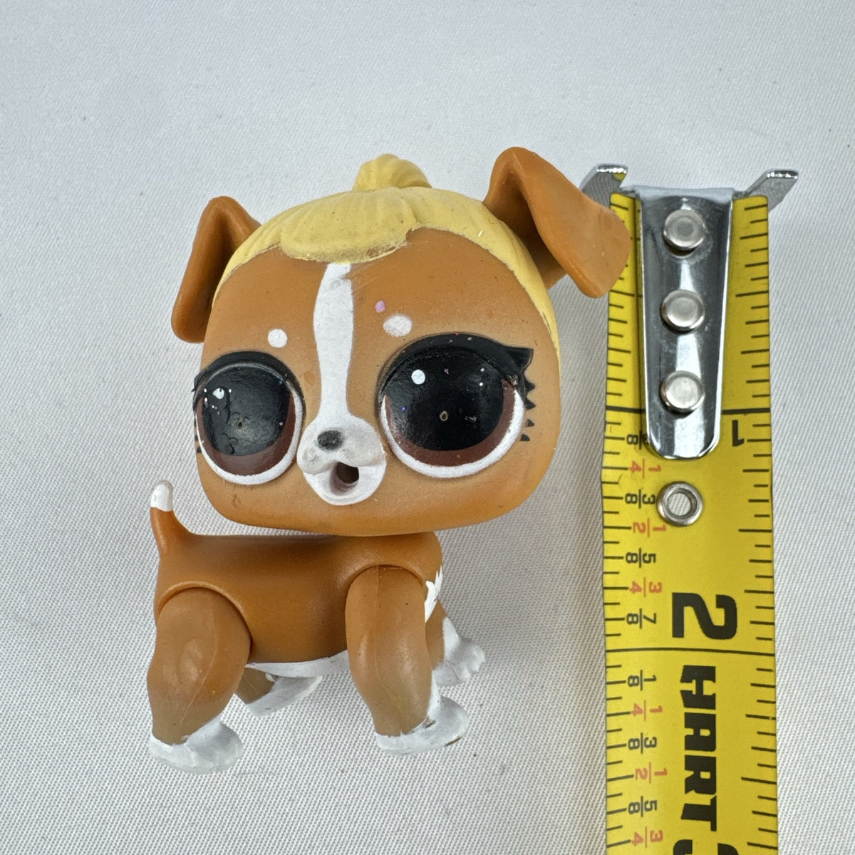 MGA L.O.L. Surprise! Pets brown vinyl dog figure with molded blonde topknot bun