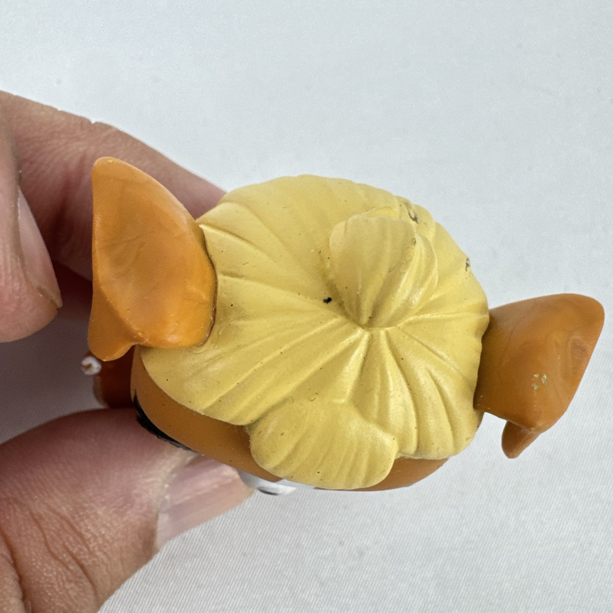 MGA L.O.L. Surprise! Pets brown vinyl dog figure with molded blonde topknot bun