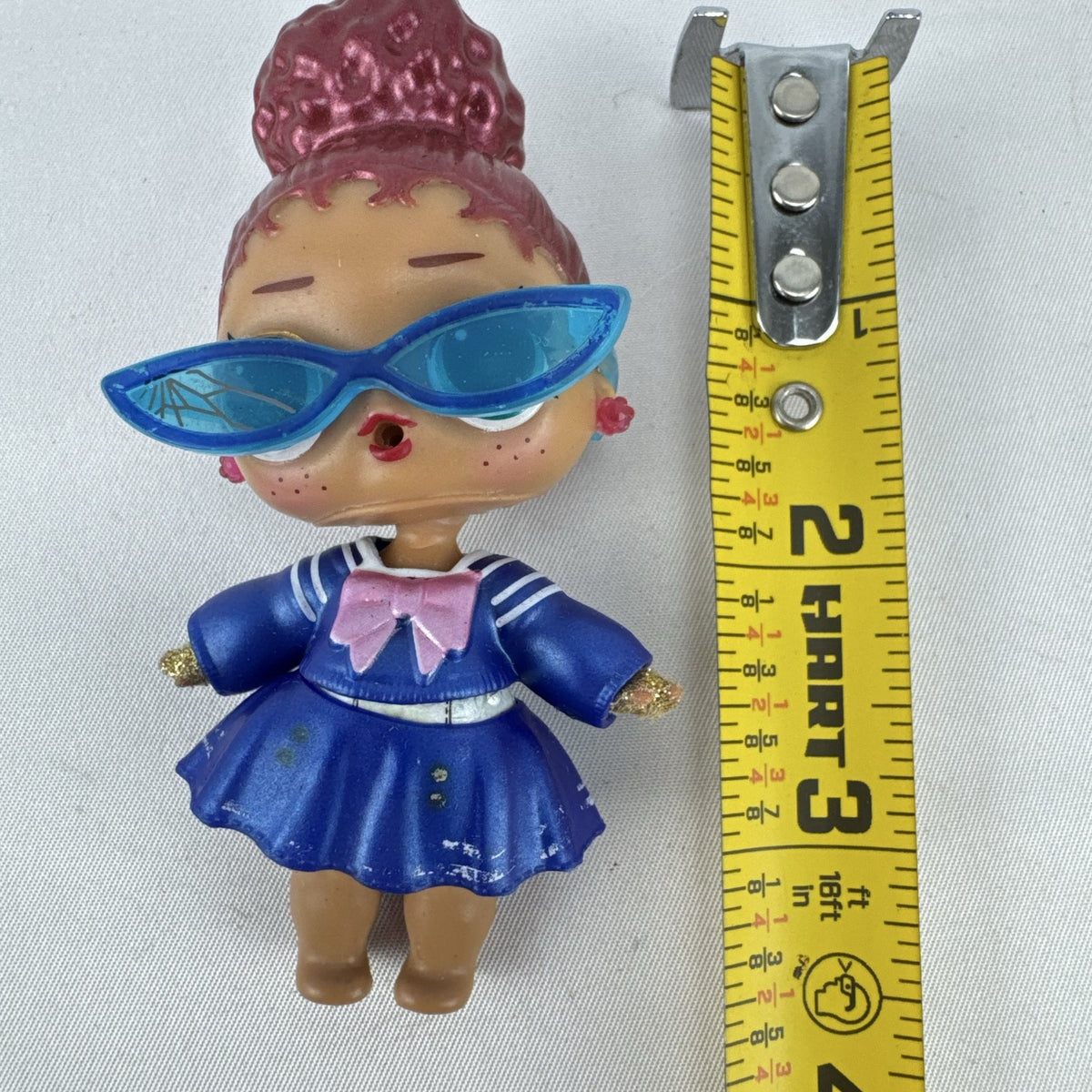 MGA Entertainment L.O.L. Surprise Jet Set Q.T. vinyl doll wearing blue sailor dress and cat-eye sunglasses
