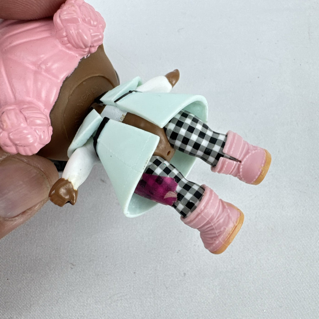 MGA L.O.L. Surprise Jet Set Q.T. 3-inch doll wearing a mint green trench coat, red sunglasses, and pink boots