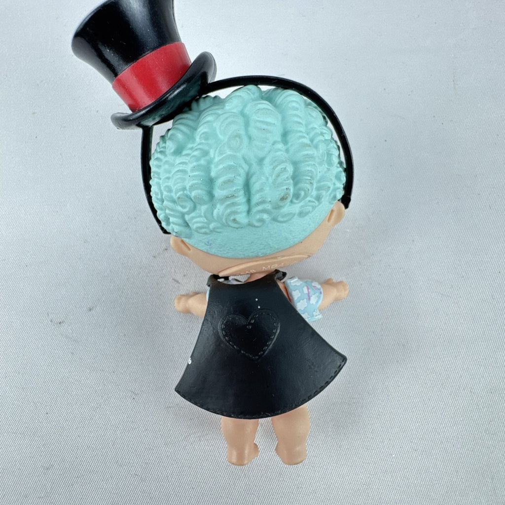 MGA Entertainment L.O.L. Surprise! The Great Baby doll with curly turquoise hair, top hat headband, and black cape.