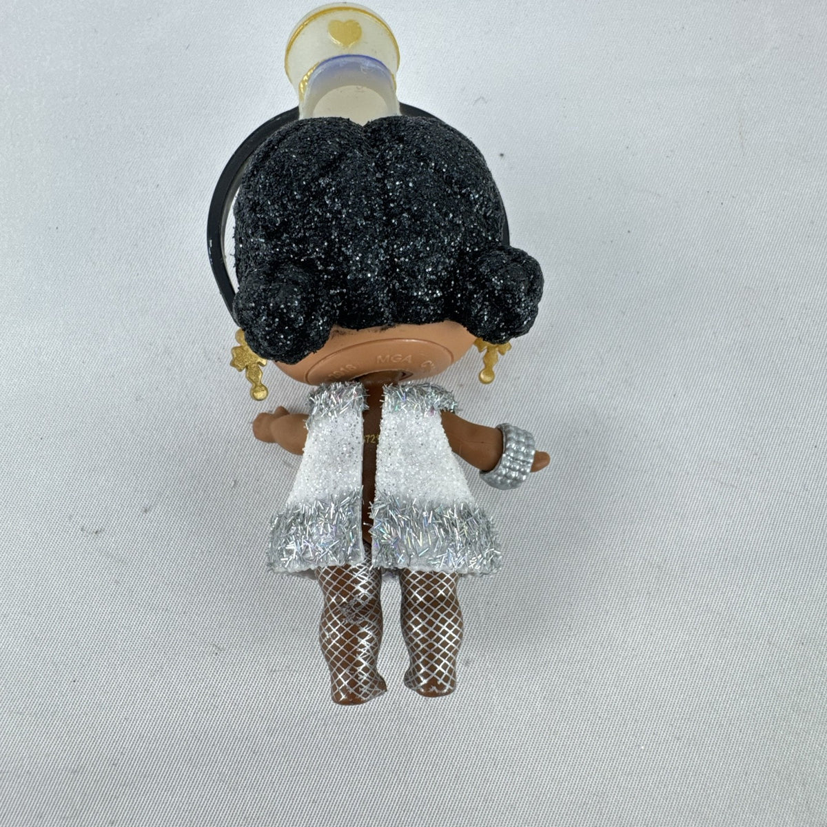 MGA L.O.L. Surprise 3-inch doll with black glitter hair buns and silver tinsel dress