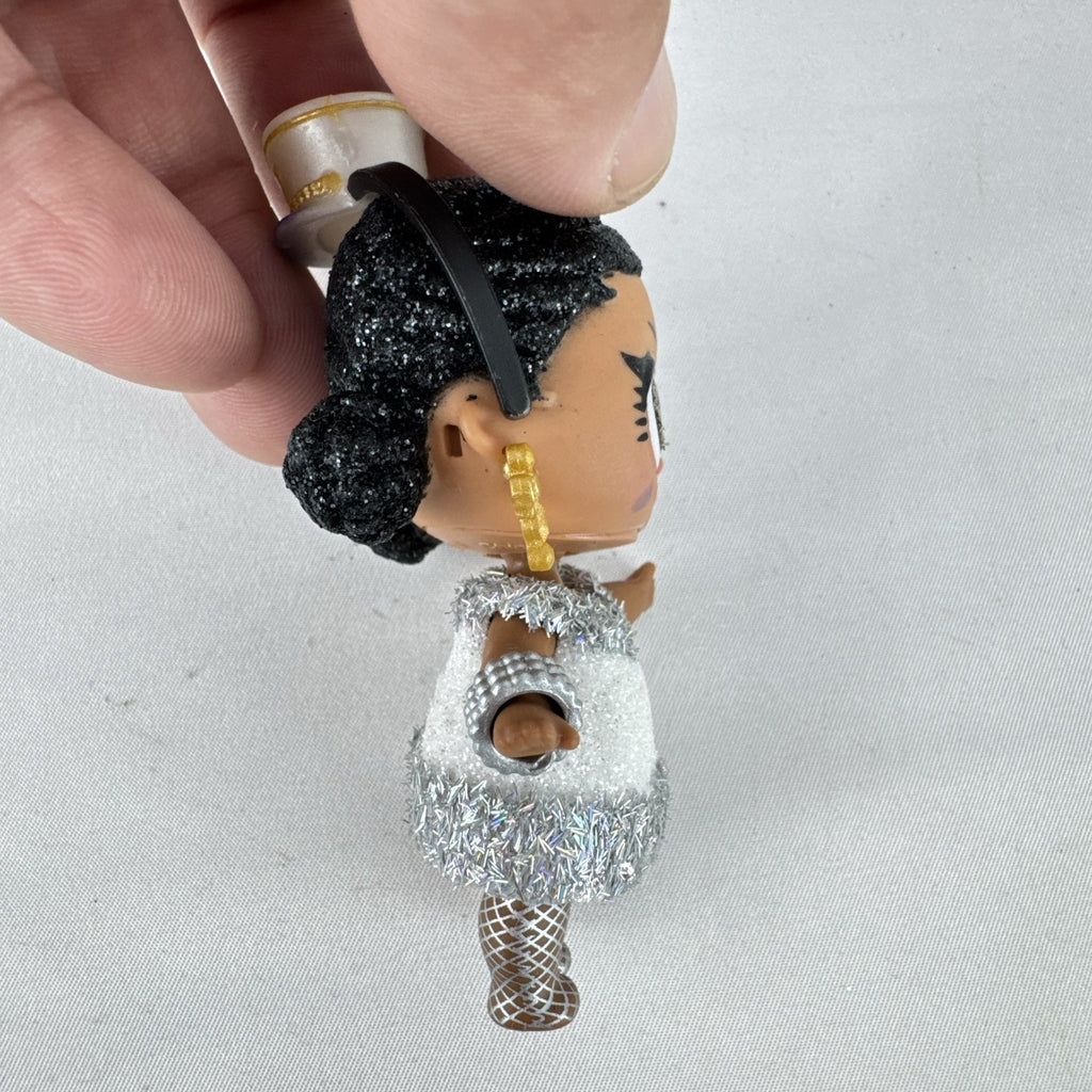 MGA L.O.L. Surprise 3-inch doll with black glitter hair buns and silver tinsel dress