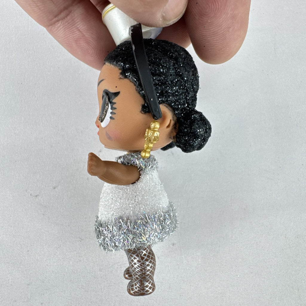 MGA L.O.L. Surprise 3-inch doll with black glitter hair buns and silver tinsel dress